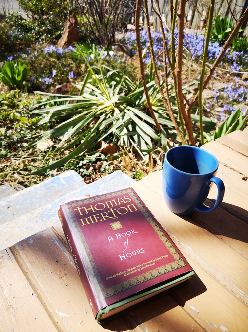 Prayer book and tea cup on the porch (Thomas Merton, A Book of Hours)