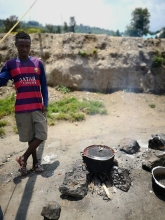 Pascale shows me a cooking fire a fisherman was cooking beans over